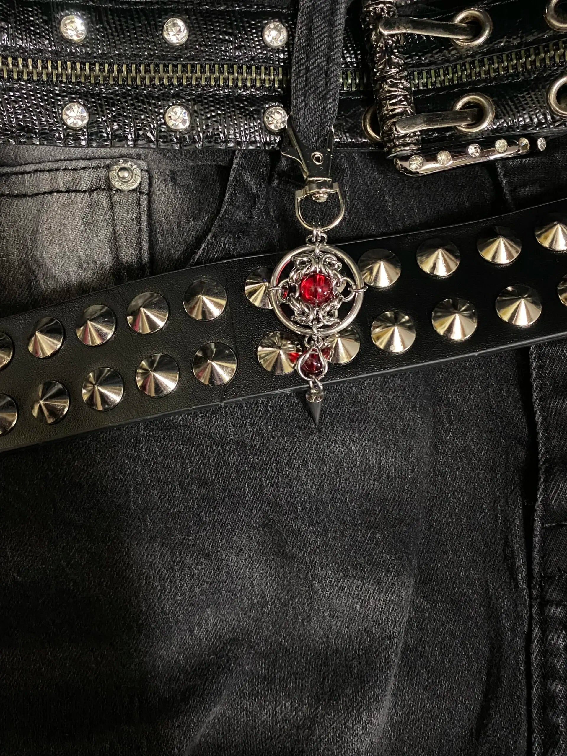 Handmade gothic metal keychain closeup showing chainmail rings and spike