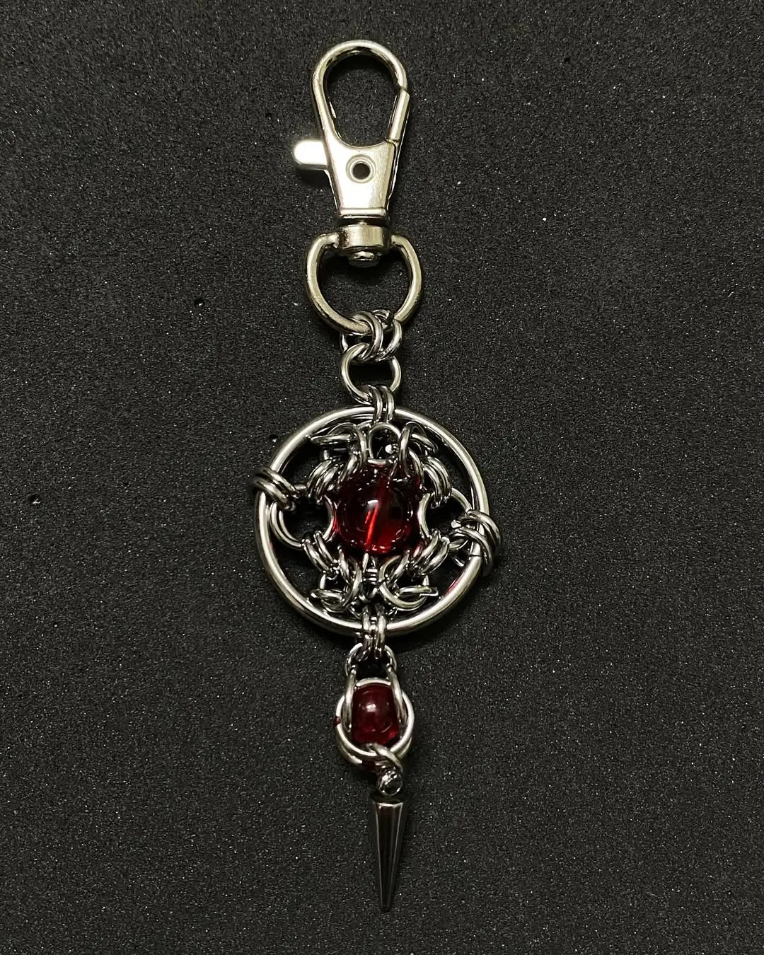 Gothic chainmail keychain with red glass core and steel spike pendant